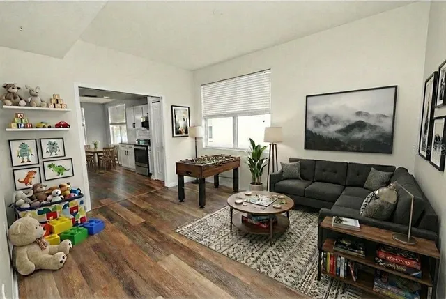 a spacious bedroom with a bed a couch and a window