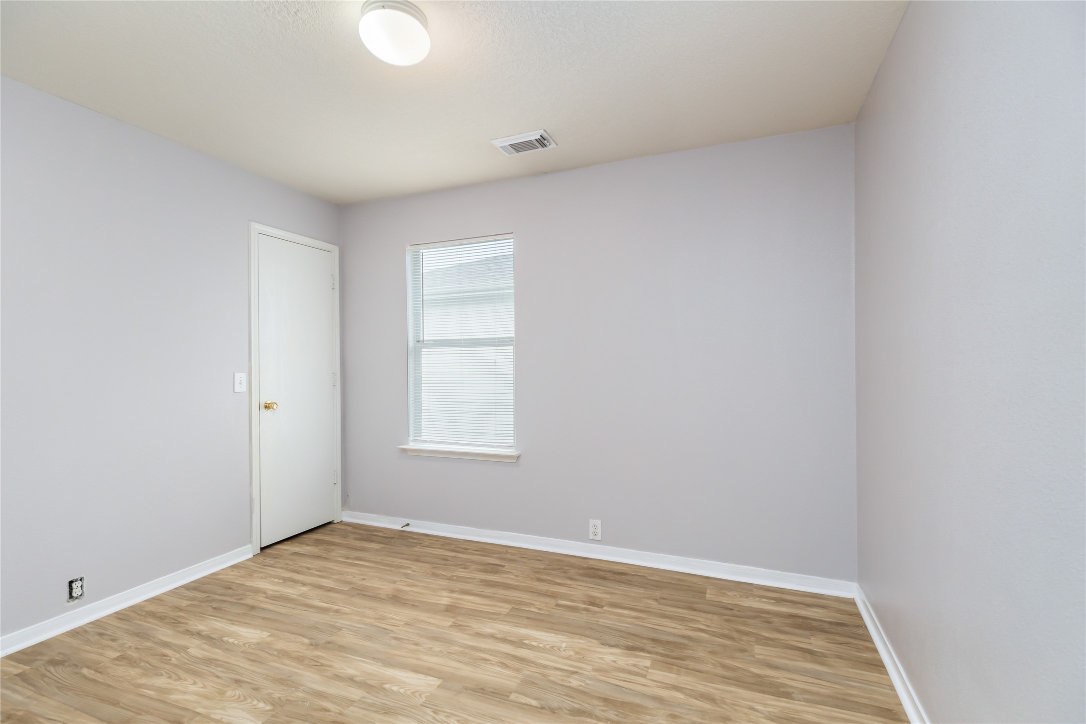 17334 Turquoise Stream Drive Houston, TX 77095 - Photo 15 of 31 a view of an empty room with wooden floor and a window