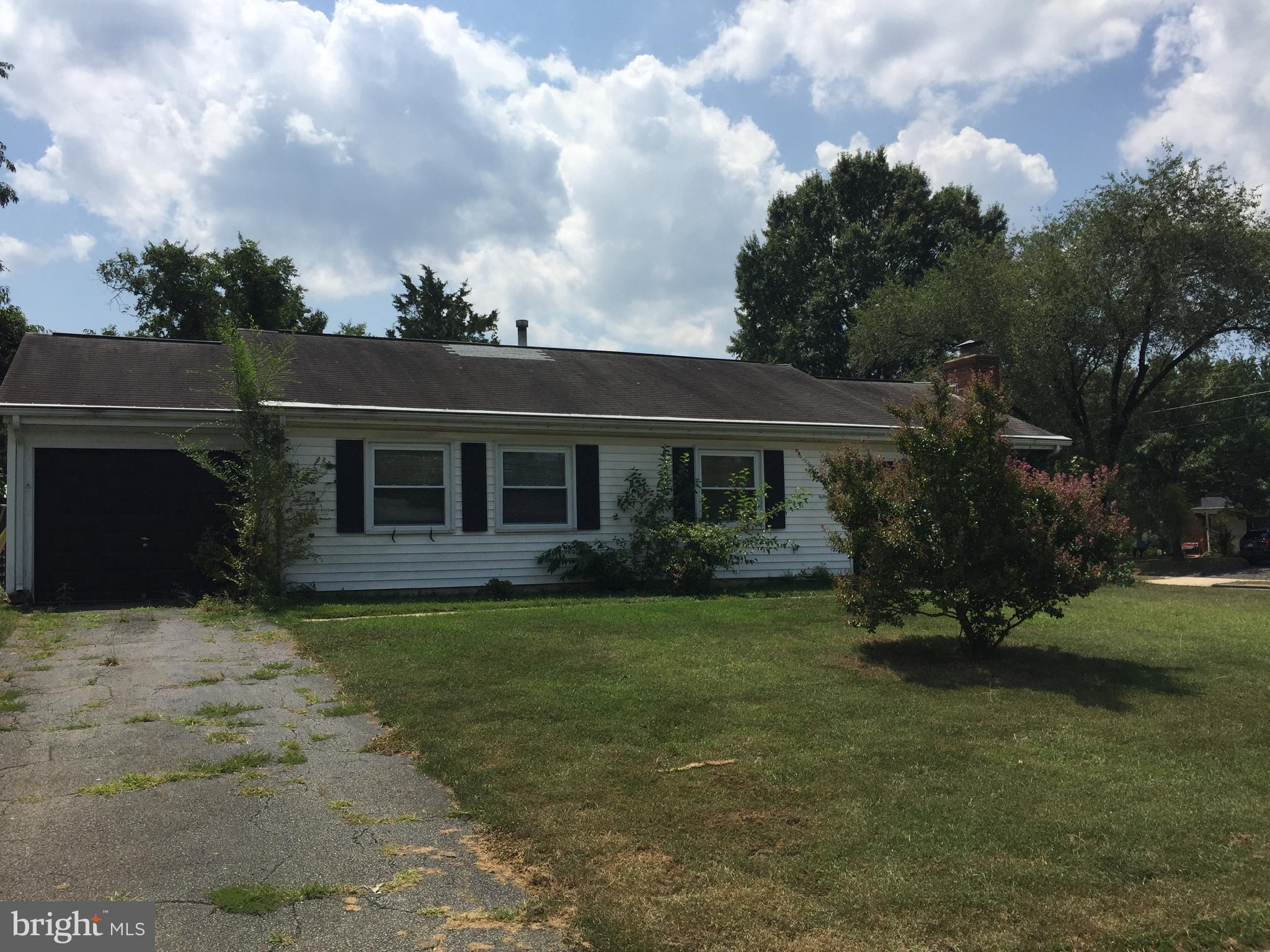 6613 Cimarron Street Springfield, VA 22150 - Photo 3 of 14 a front view of a house with a garden