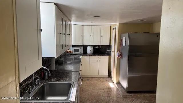 a kitchen with a refrigerator and a stove