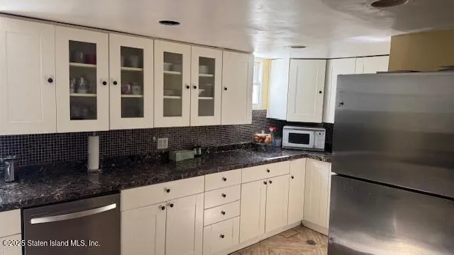 a kitchen with granite countertop a sink and a stove
