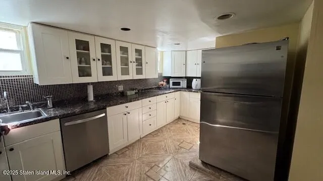 a kitchen with a refrigerator and a sink