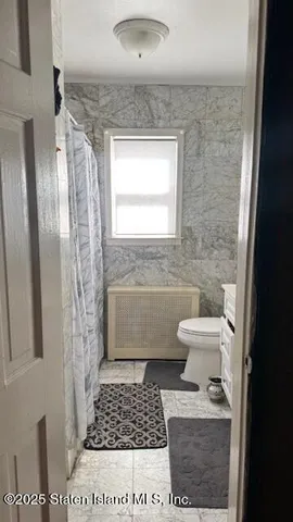 a bathroom with a toilet a sink and a shower