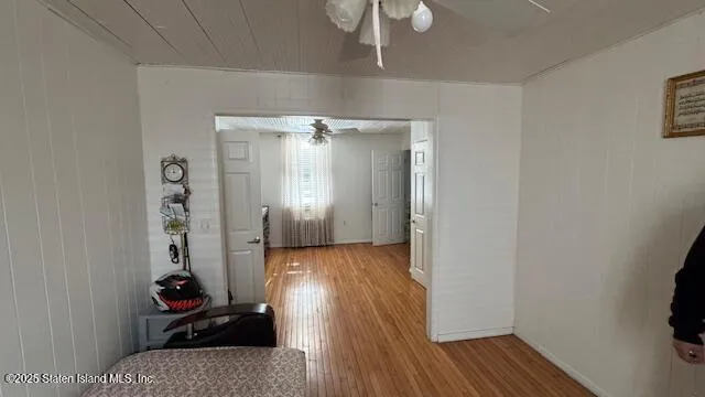 a view of a hallway with wooden floor and workspace