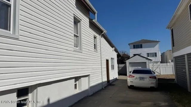a white car parked in front of a house