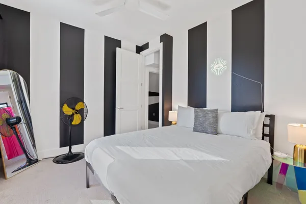 a bedroom with a bed and a night stand
