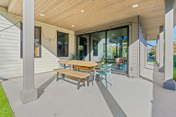 a backyard of a house with table and chairs