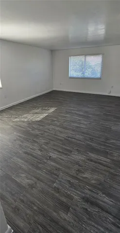 an empty room with wooden floor