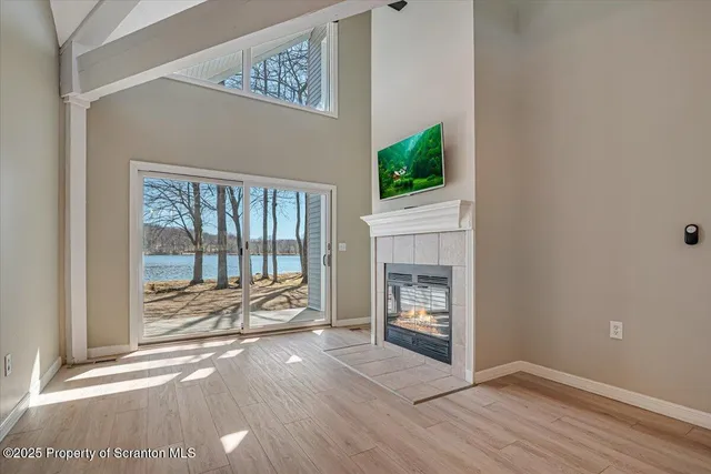 a view of a room with kitchen and fireplace