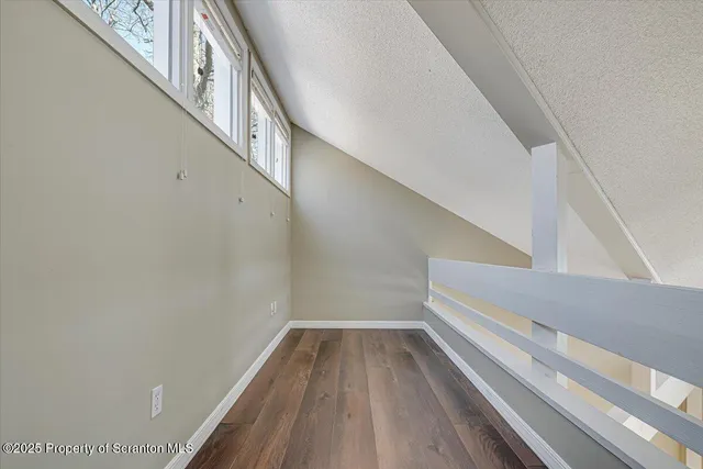 a view of a wooden balcony with an outdoor space