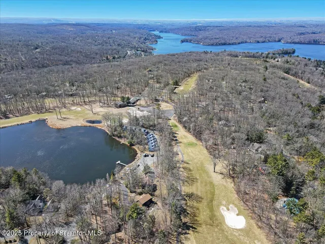a front view of a house with a tree
