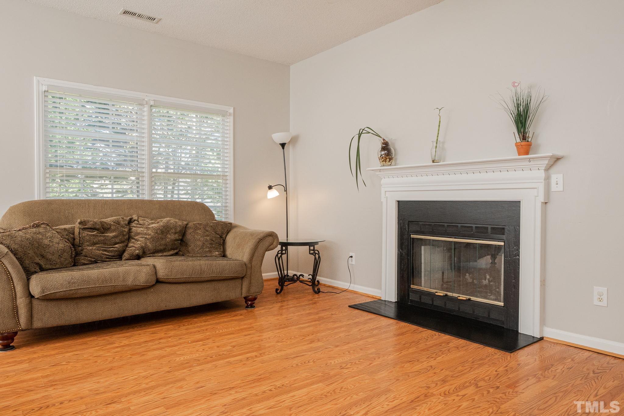 114 Calebra Way Cary, NC 27519 - Photo 11 of 50 a living room with furniture and a fireplace