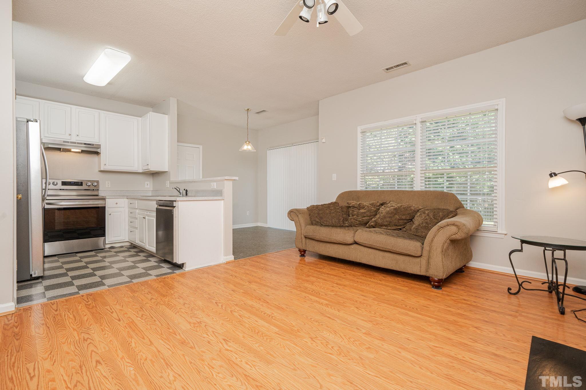 114 Calebra Way Cary, NC 27519 - Photo 13 of 50 a living room with stainless steel appliances kitchen island granite countertop a stove and a refrigerator