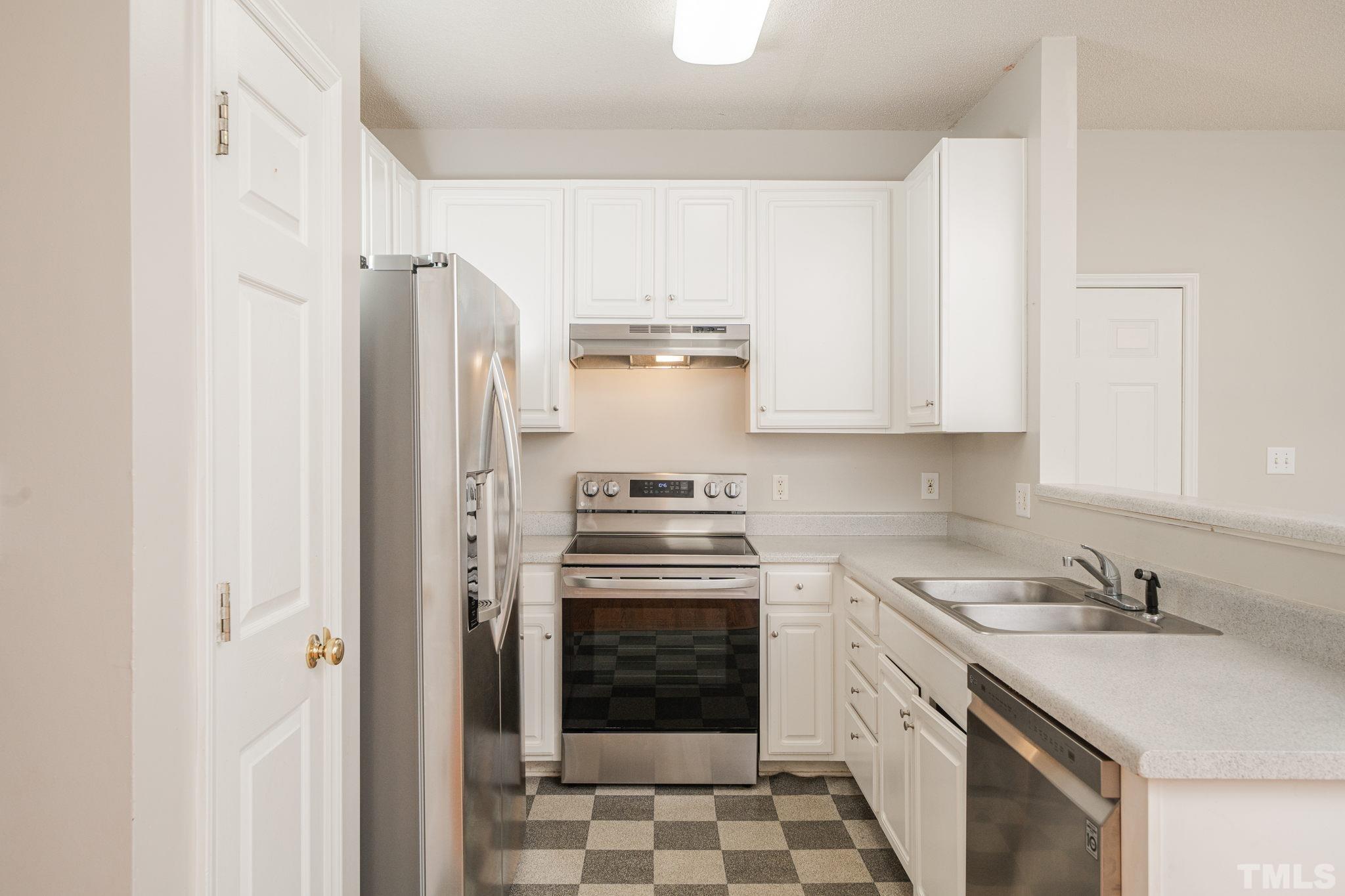 114 Calebra Way Cary, NC 27519 - Photo 17 of 50 a kitchen with cabinets a stove and a refrigerator