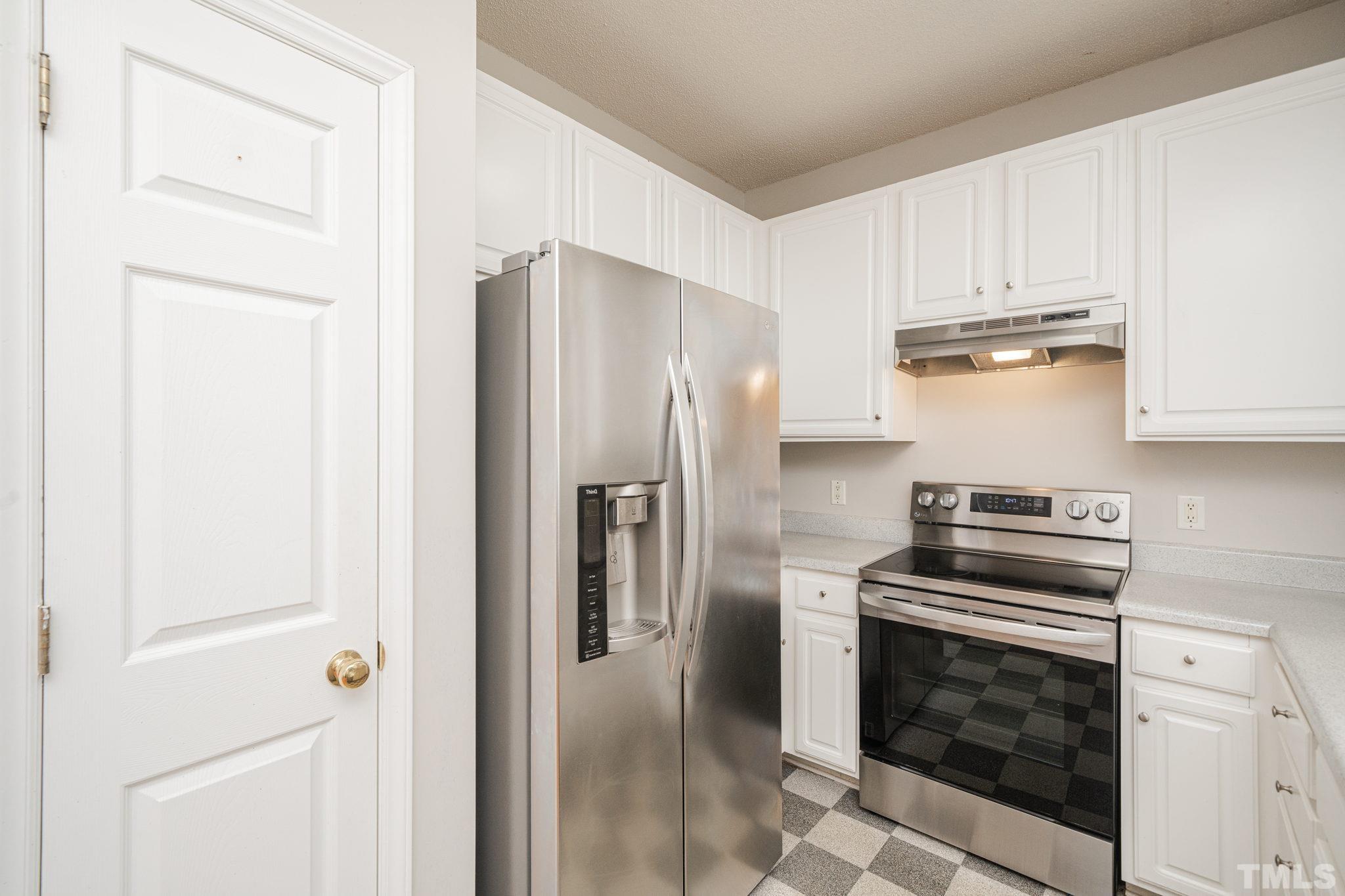 114 Calebra Way Cary, NC 27519 - Photo 20 of 50 a kitchen with stainless steel appliances granite countertop a refrigerator and a stove
