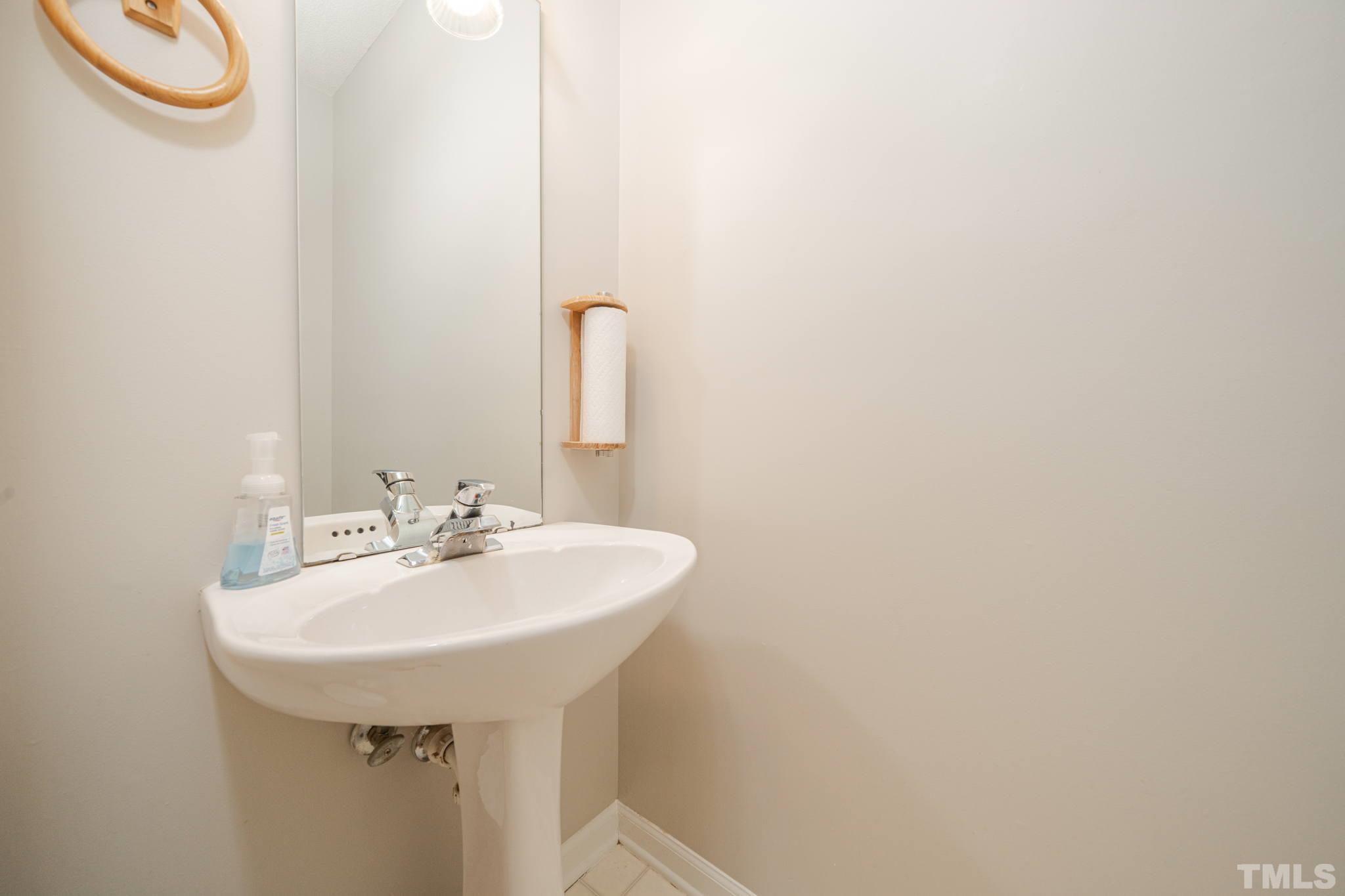 114 Calebra Way Cary, NC 27519 - Photo 21 of 50 a bathroom with a sink and a mirror