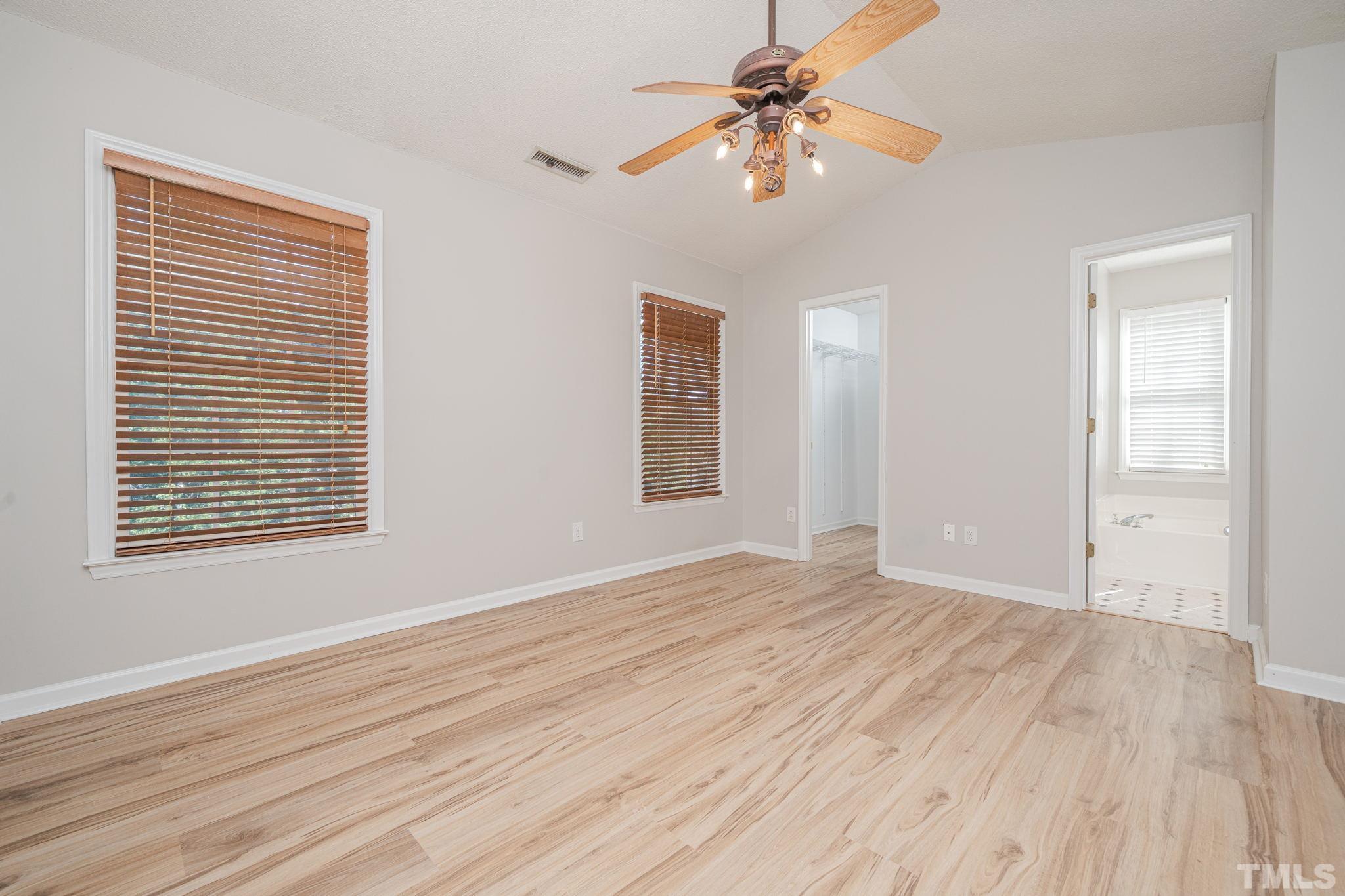 114 Calebra Way Cary, NC 27519 - Photo 24 of 50 a view of an empty room with wooden floor and a window