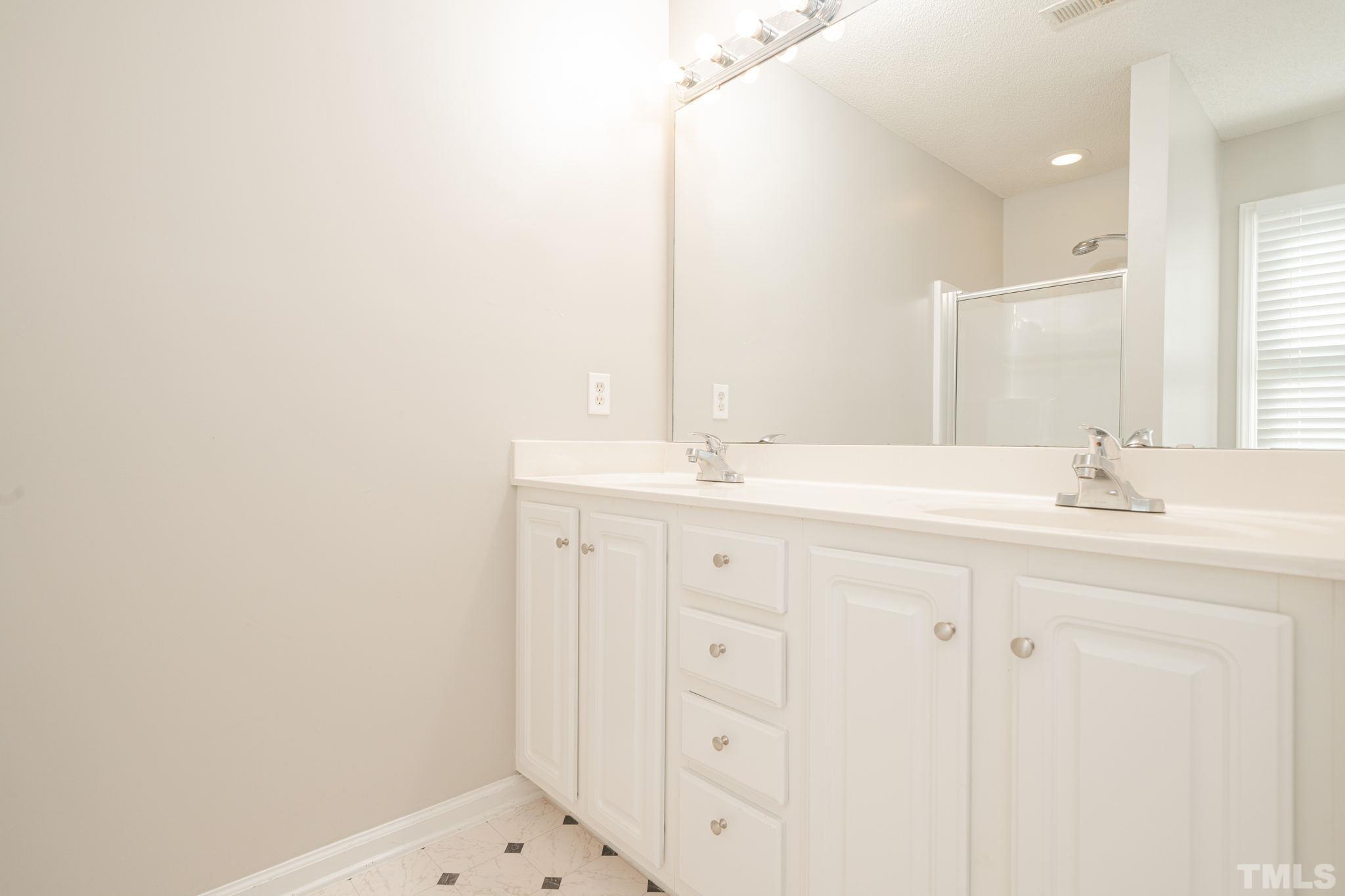 114 Calebra Way Cary, NC 27519 - Photo 26 of 50 a bathroom with a sink and a mirror
