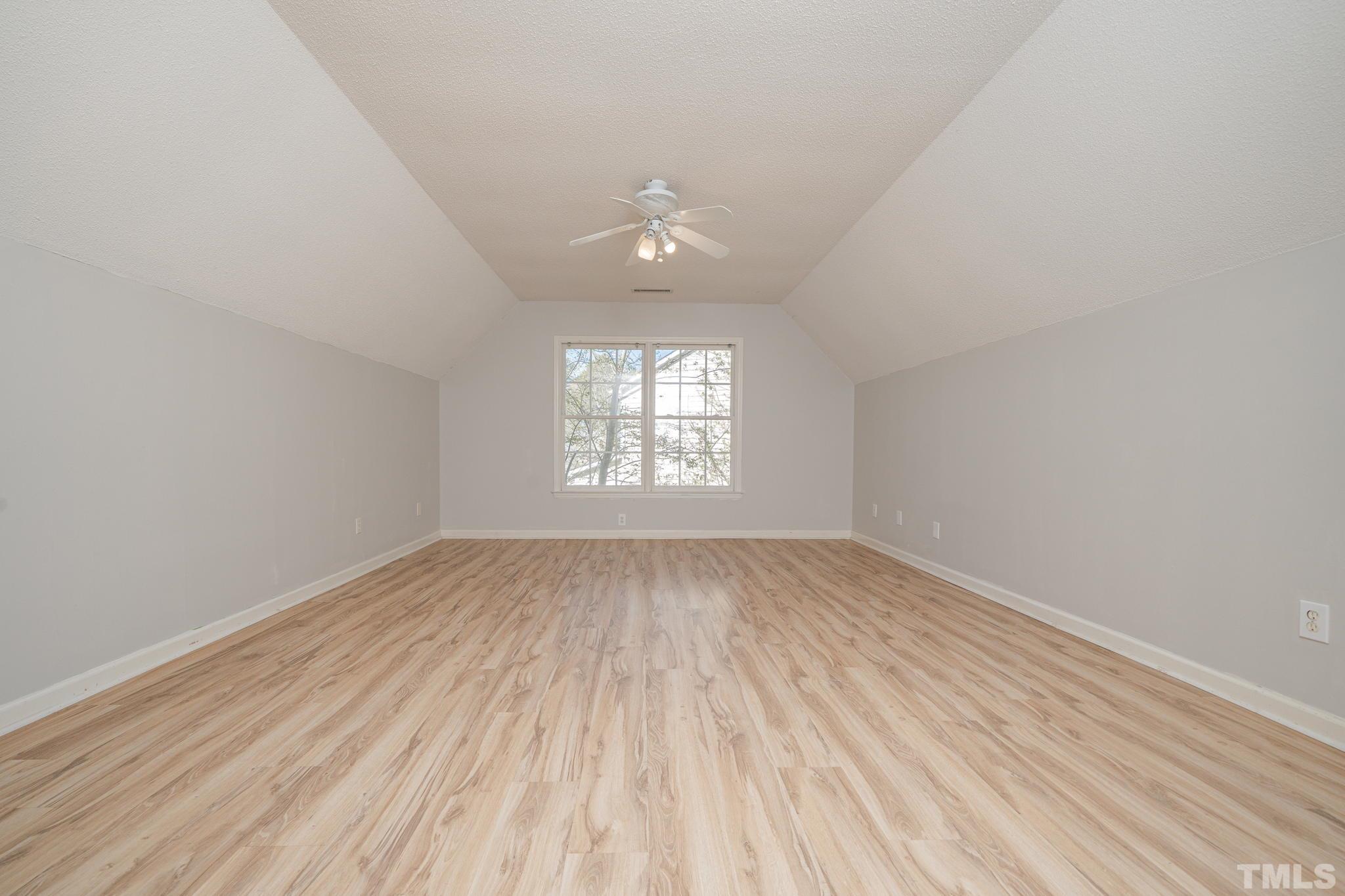 114 Calebra Way Cary, NC 27519 - Photo 29 of 50 an empty room with wooden floor and windows