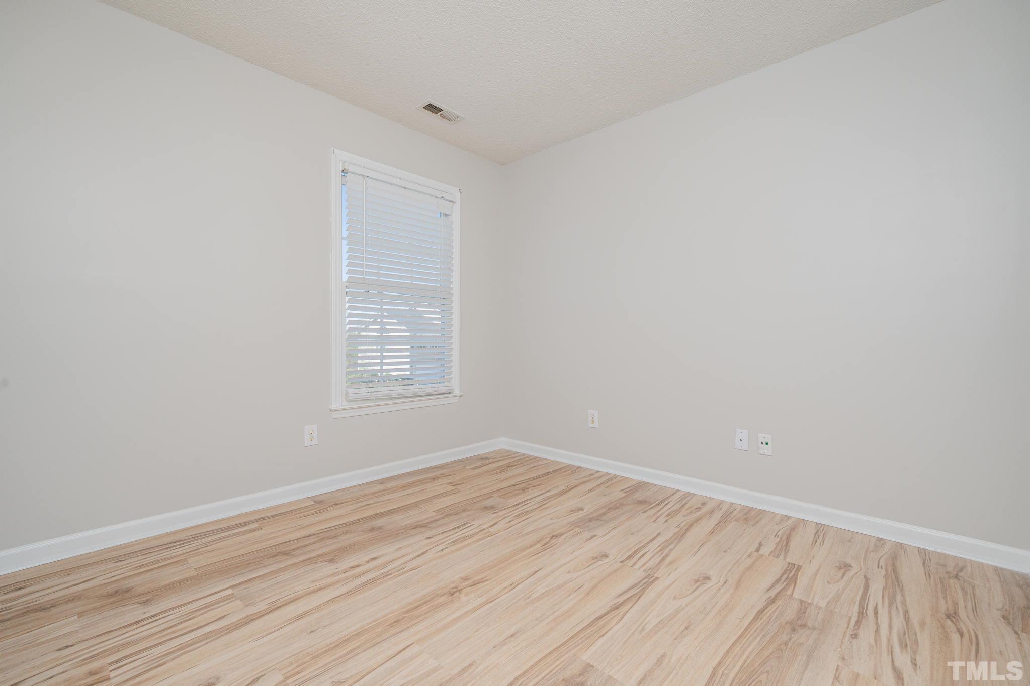 114 Calebra Way Cary, NC 27519 - Photo 34 of 50 an empty room with wooden floor and windows