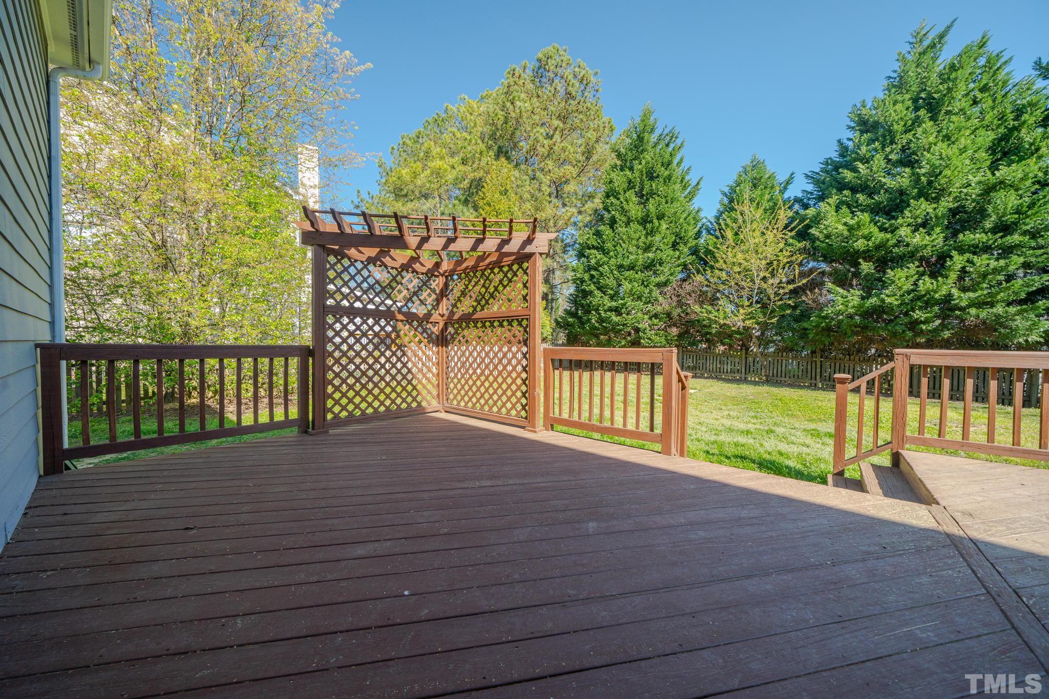 114 Calebra Way Cary, NC 27519 - Photo 38 of 50 a view of a balcony with a floor to ceiling window and wooden fence