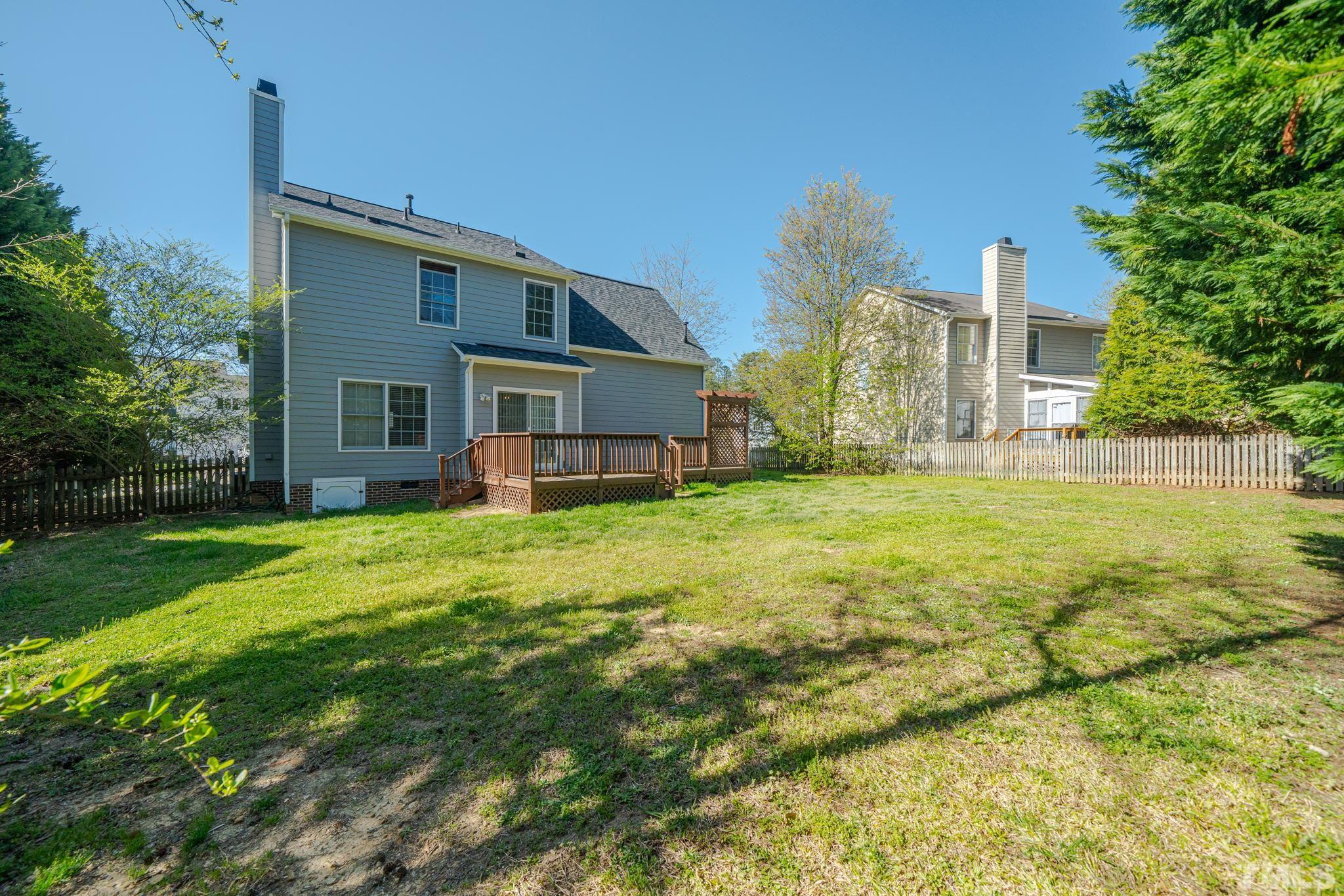 114 Calebra Way Cary, NC 27519 - Photo 48 of 50 a view of a house with a yard and a garden