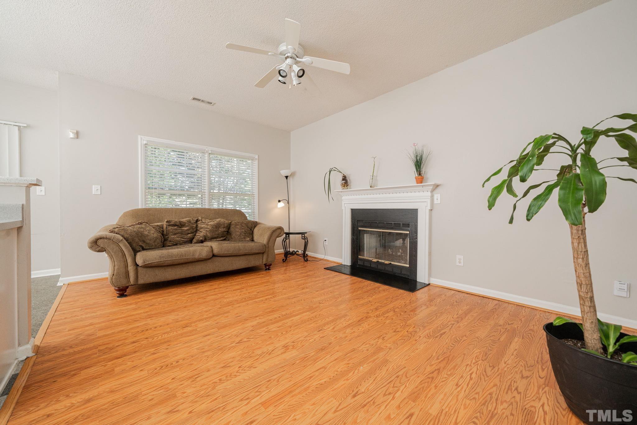 114 Calebra Way Cary, NC 27519 - Photo 9 of 50 a living room with furniture and a fireplace