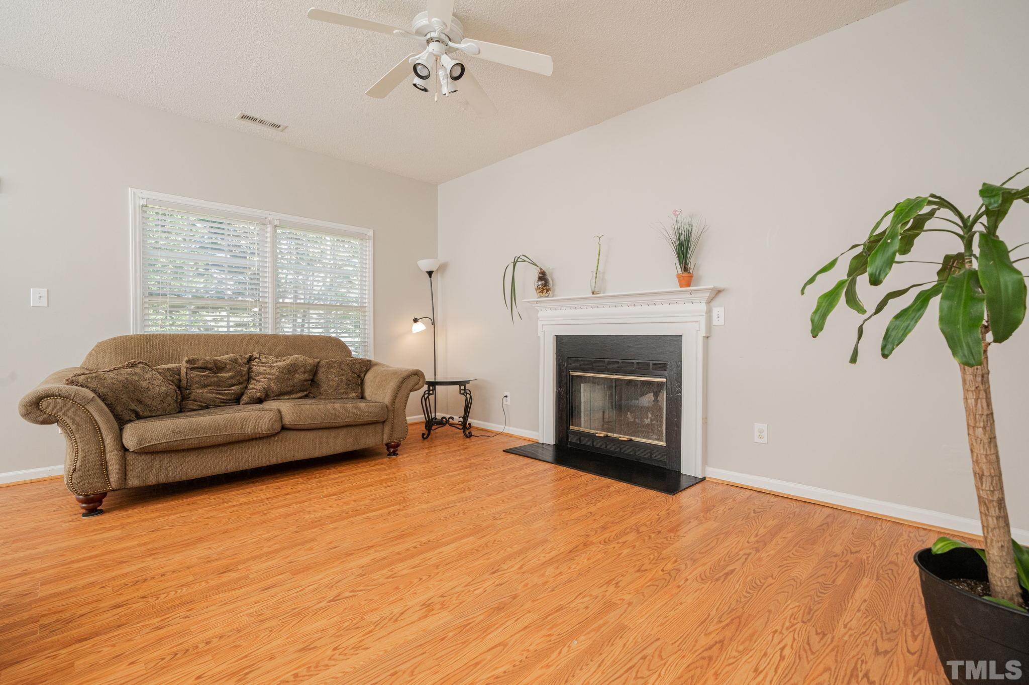 114 Calebra Way Cary, NC 27519 - Photo 10 of 50 a living room with furniture and a fireplace