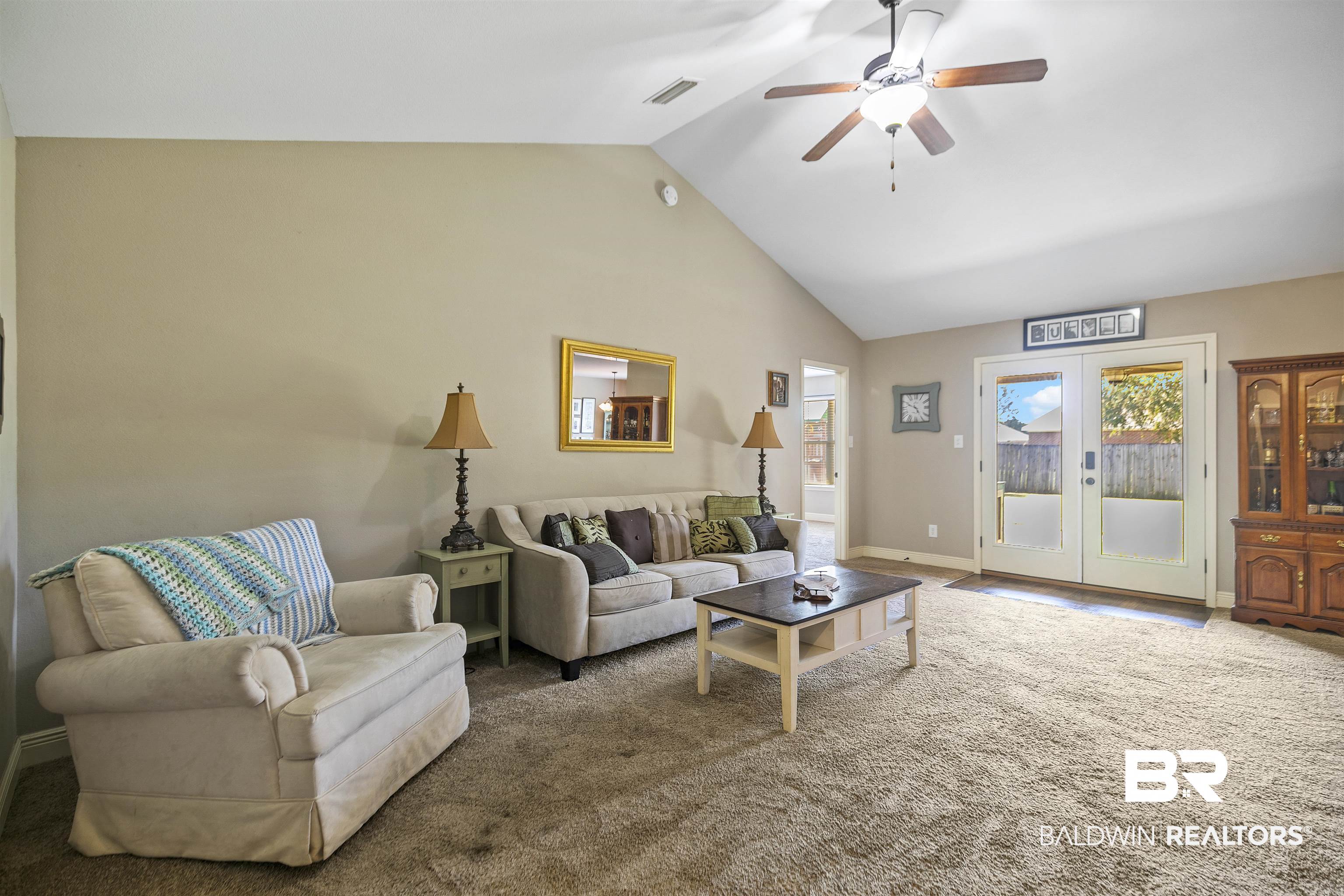 18738 Explorer Drive Loxley, AL 36551 - Photo 10 of 38 Living room with high vaulted ceiling, ceiling fan, carpet floors, and french doors