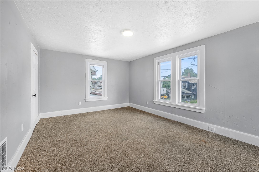 885 Wales Road Northeast Massillon, OH 44646 - Photo 16 of 34 Neutral gray wall paint complementing a textured ceiling