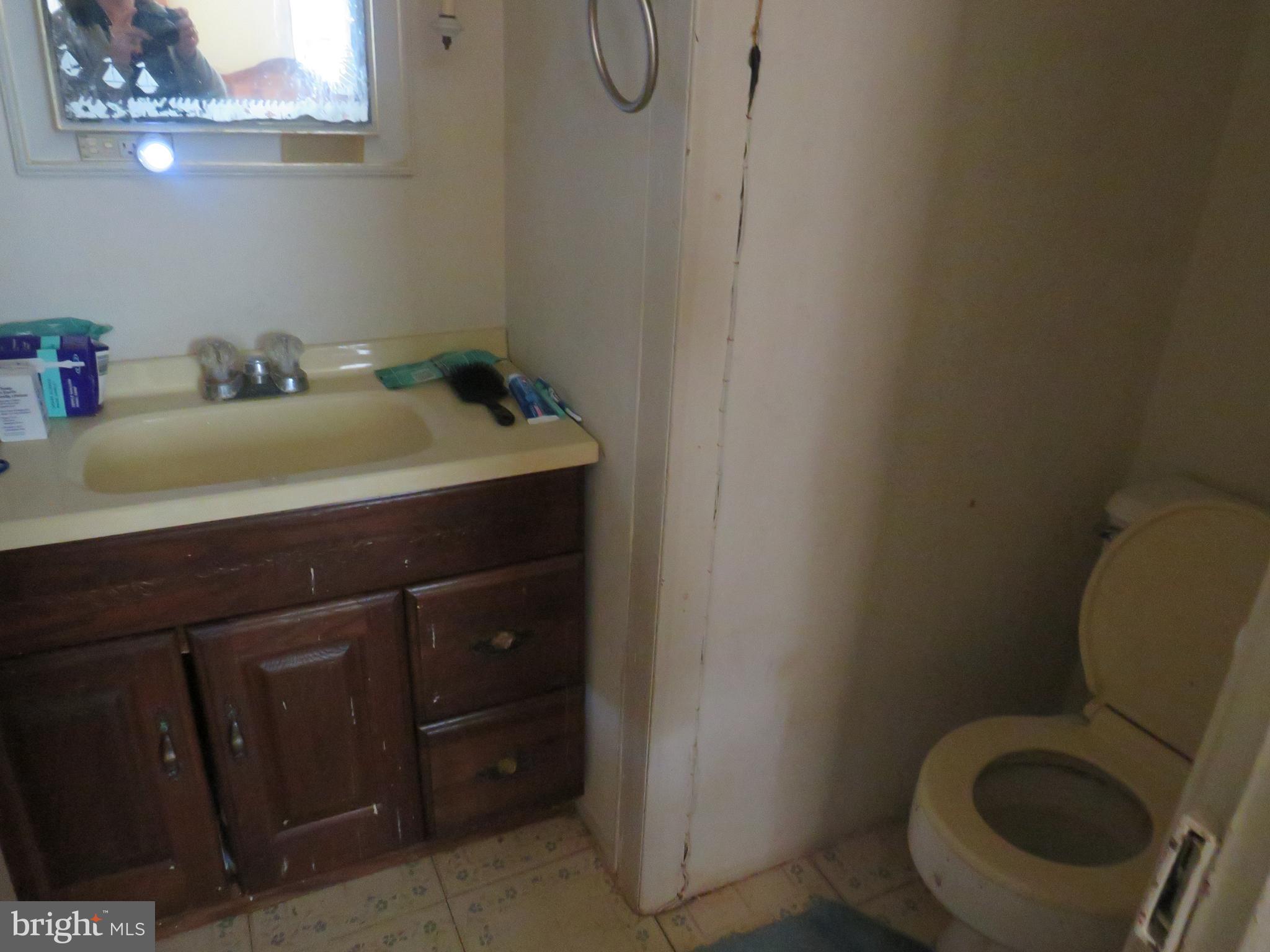 26955 Johnson Creek Road Crisfield, MD 21817 - Photo 15 of 35 a bathroom with a sink vanity and toilet