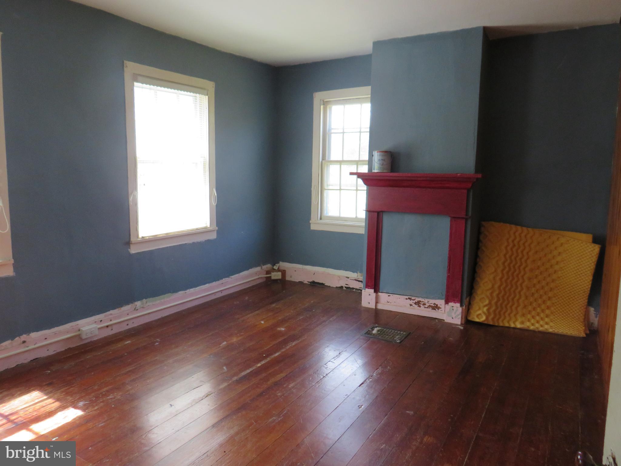 26955 Johnson Creek Road Crisfield, MD 21817 - Photo 23 of 35 an empty room with wooden floor and windows