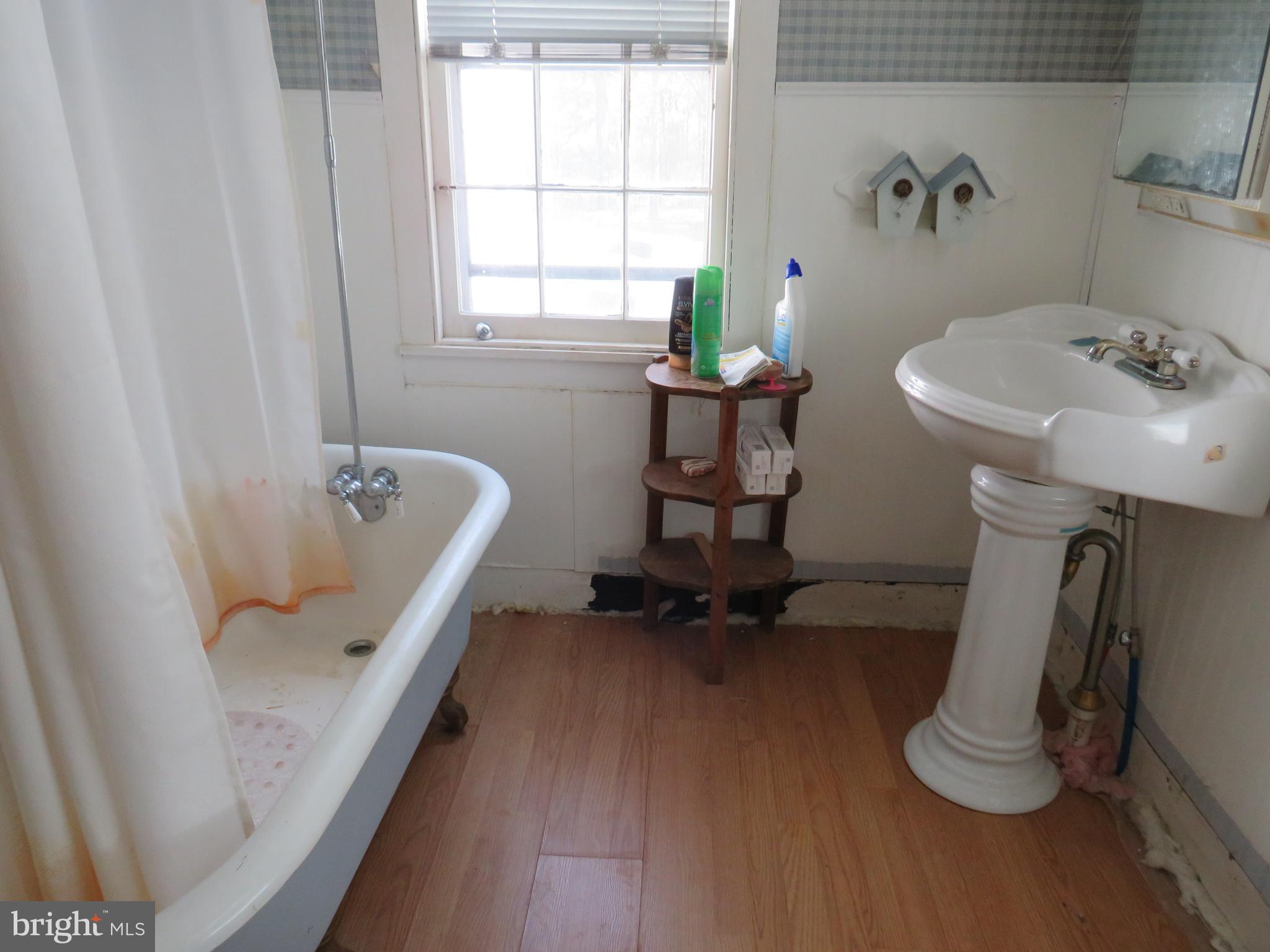 26955 Johnson Creek Road Crisfield, MD 21817 - Photo 25 of 35 a bathroom with a tub sink and mirror