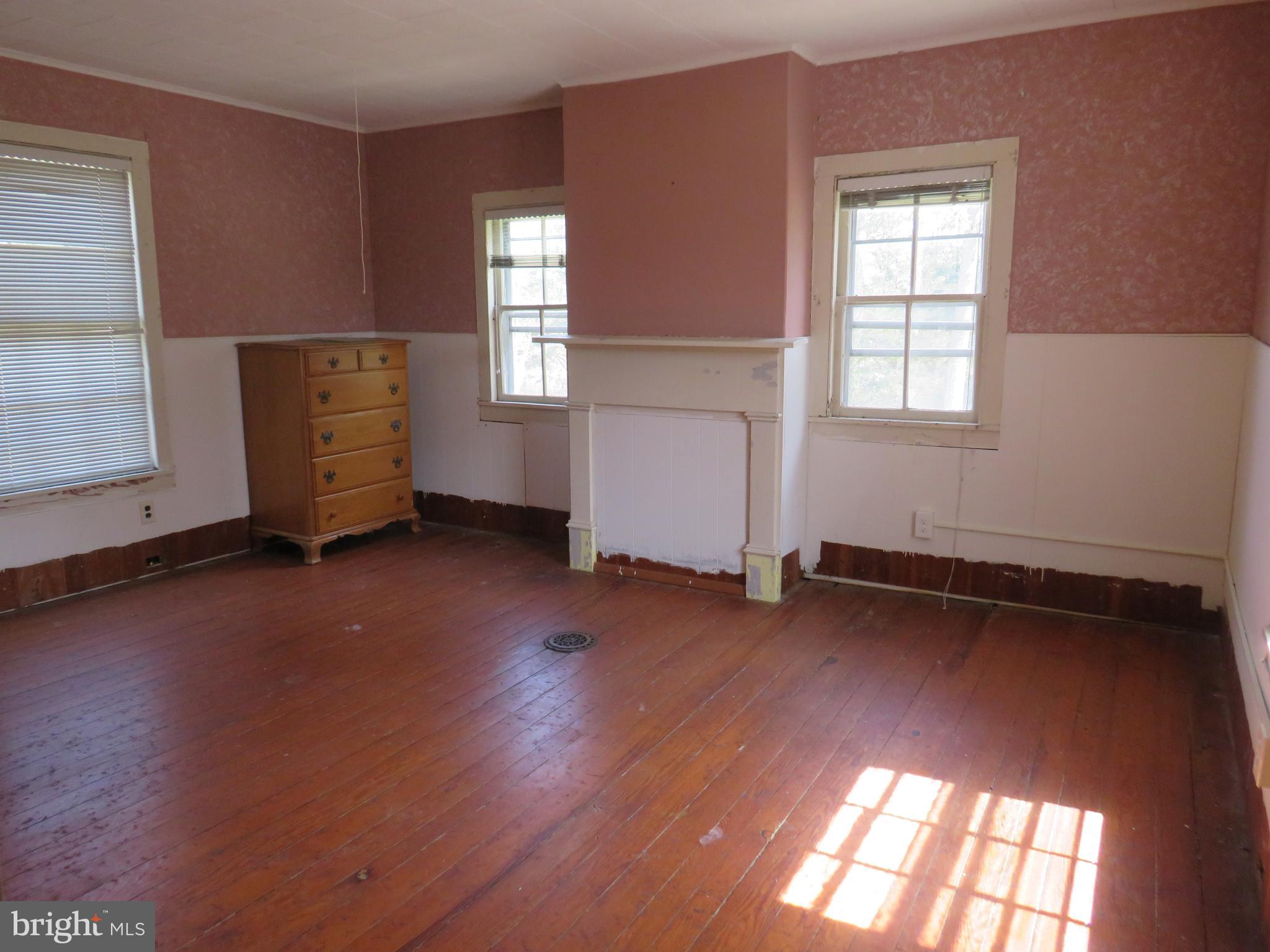 26955 Johnson Creek Road Crisfield, MD 21817 - Photo 28 of 35 an empty room with wooden floor and windows