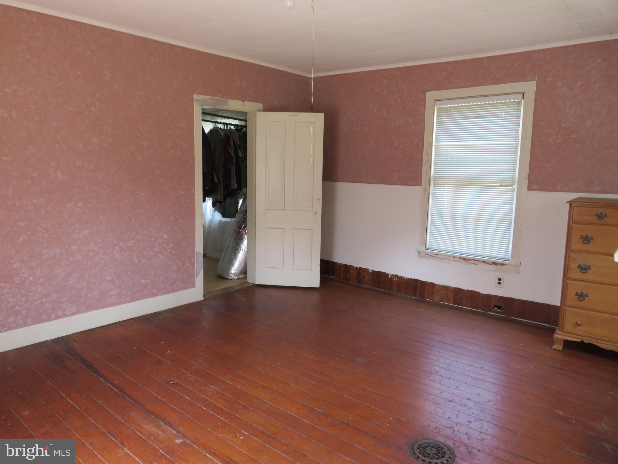 26955 Johnson Creek Road Crisfield, MD 21817 - Photo 29 of 35 a view of an empty room with wooden floor and a window