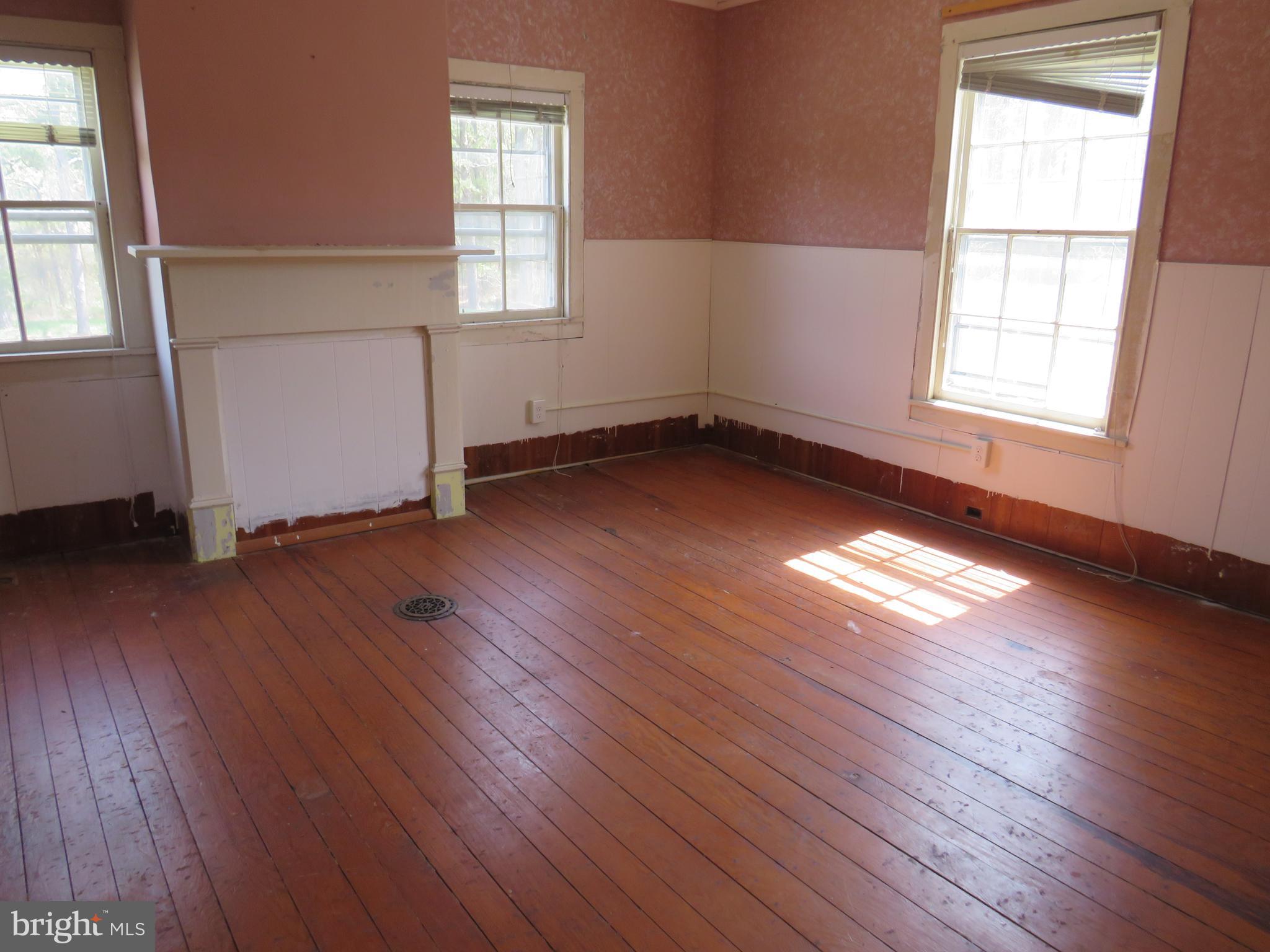 26955 Johnson Creek Road Crisfield, MD 21817 - Photo 30 of 35 an empty room with wooden floor and windows