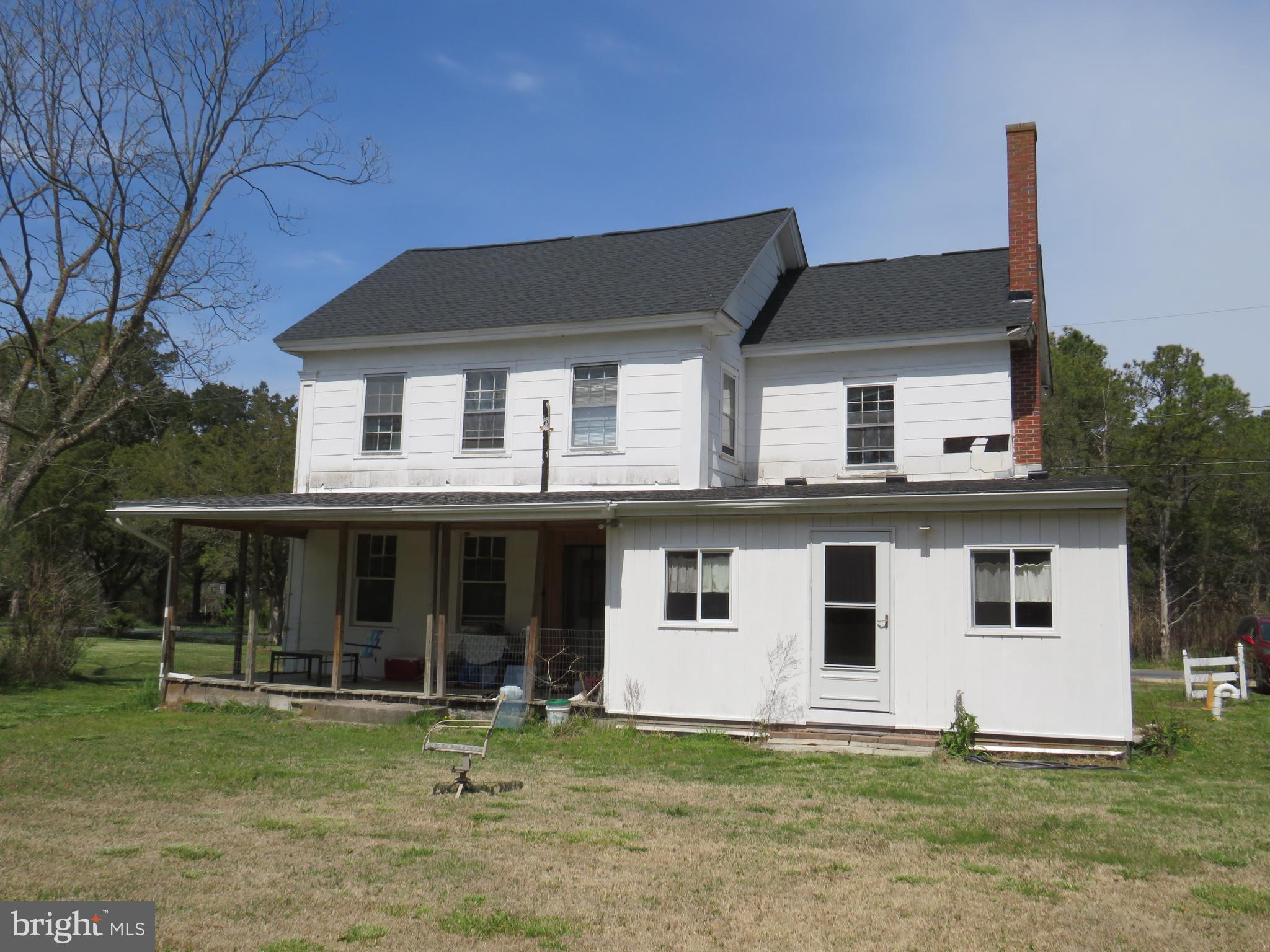 26955 Johnson Creek Road Crisfield, MD 21817 - Photo 4 of 35 a white house that has a big yard in front of it