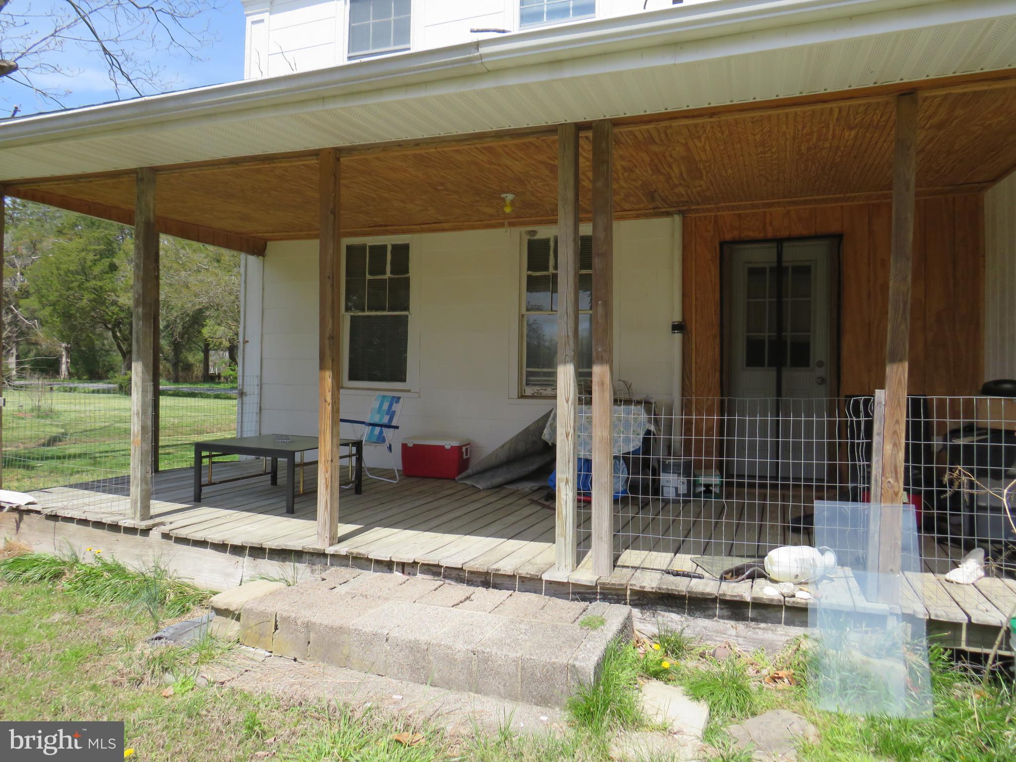 26955 Johnson Creek Road Crisfield, MD 21817 - Photo 5 of 35 a backyard of a house with seating space