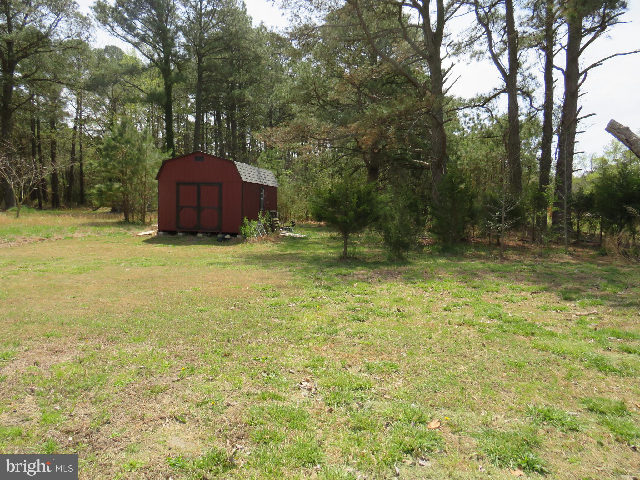 26955 Johnson Creek Road Crisfield, MD 21817 - Photo 6 of 35 a view of a tiny house with a yard