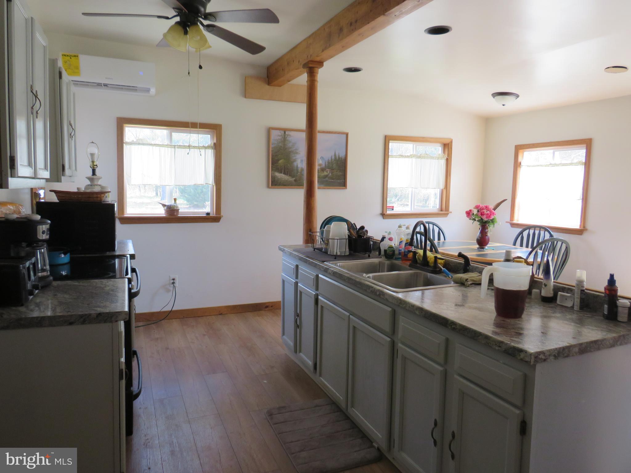 26955 Johnson Creek Road Crisfield, MD 21817 - Photo 7 of 35 a kitchen with sink refrigerator and window