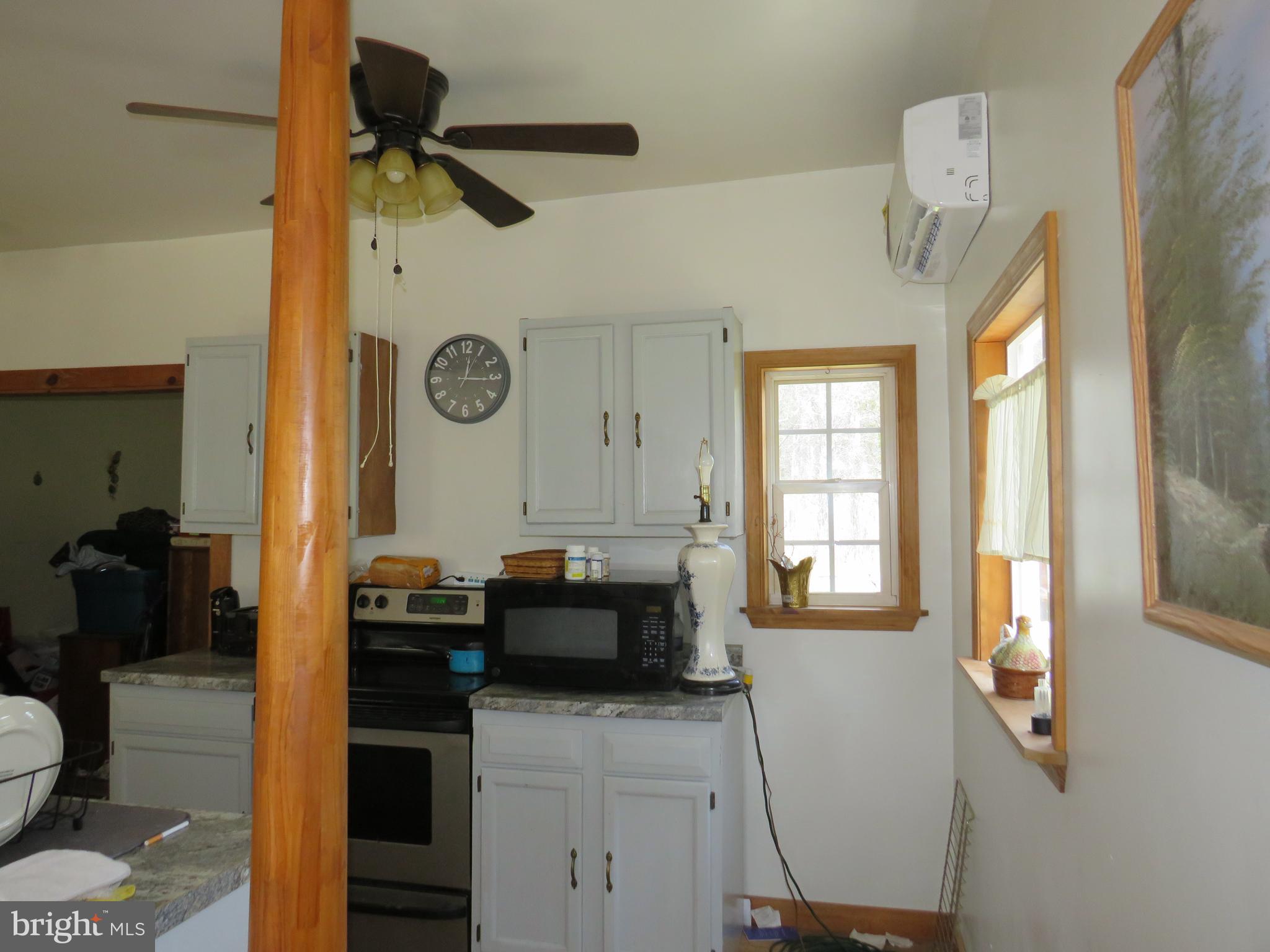 26955 Johnson Creek Road Crisfield, MD 21817 - Photo 8 of 35 a living room with a table chairs and a large window
