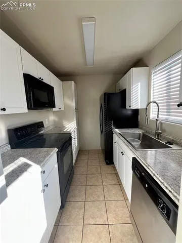 a large kitchen with a stove and a sink