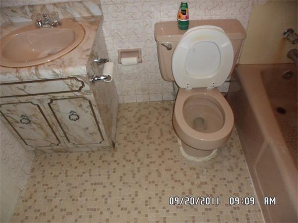 128 Mammoth Road, Unit 5 Hooksett, NH 03106 - Photo 4 of 5 a bathroom with a toilet sink and mirror