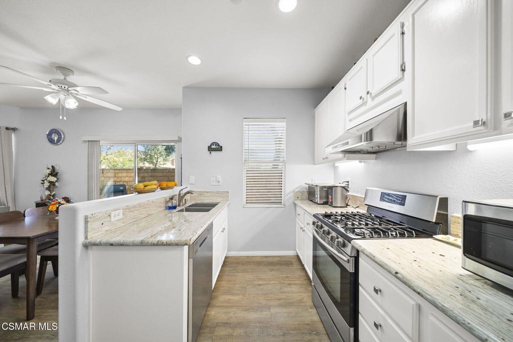 1838 Amberleaf Lane Simi Valley, CA 93065 - Photo 15 of 39 a kitchen with stainless steel appliances granite countertop a sink stove and refrigerator