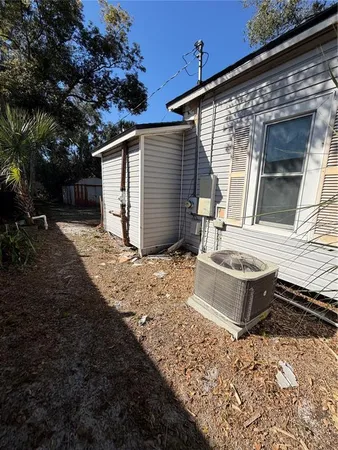 a view of a house with a yard and wooden fence