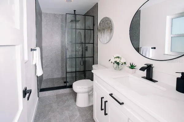 a bathroom with a sink toilet and shower