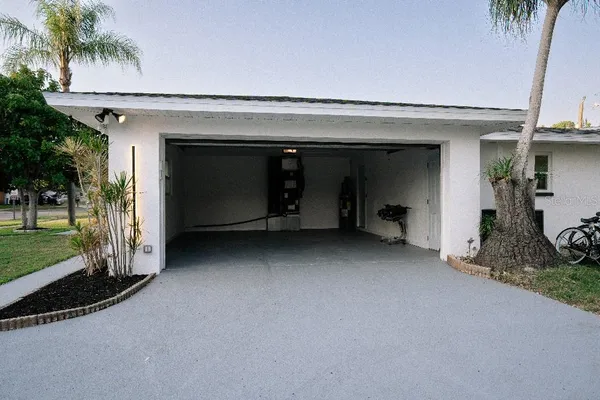 a backyard of a house with table and chairs