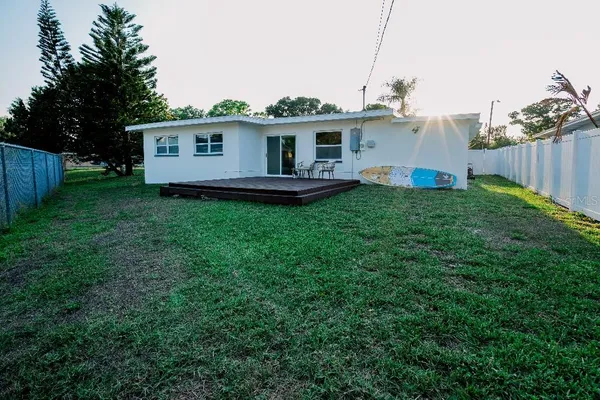 a view of a house with a garage and a yard