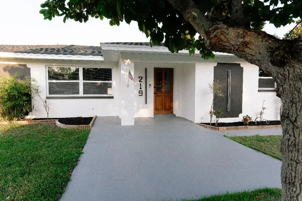 a front view of a house with a yard