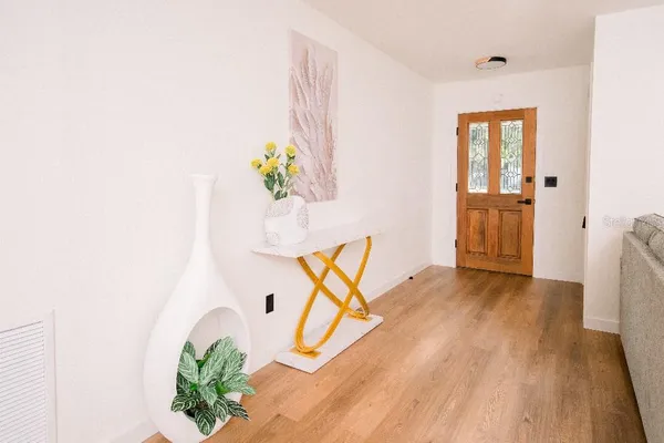 a kitchen with stainless steel appliances granite countertop a sink a stove and white cabinets